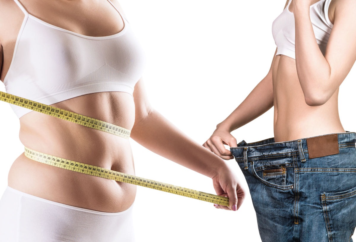 measuring tape around belly showing weight loss